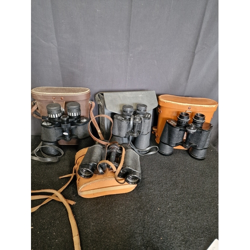 129 - Four pairs of vintage binoculars with original cases and Lens Caps
