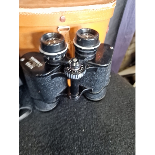 129 - Four pairs of vintage binoculars with original cases and Lens Caps