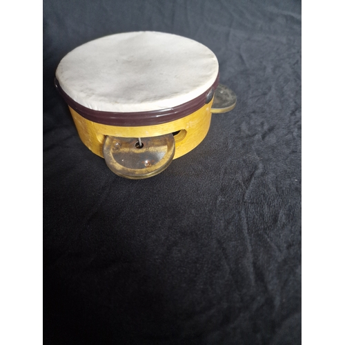 28 - A vintage thunder tube and small tambourine