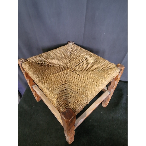 32 - A vintage wooden footstool with woven top