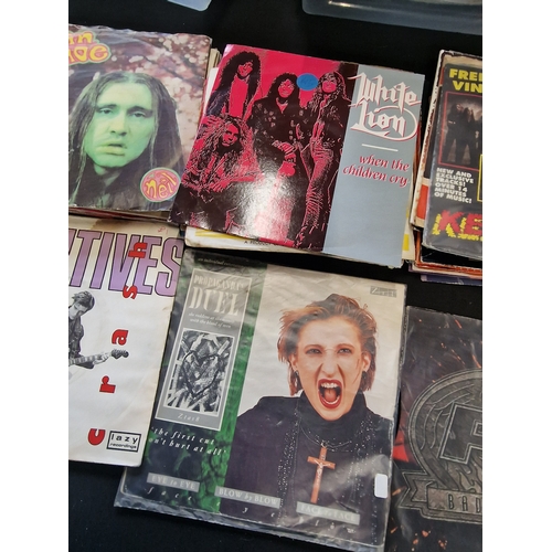 34 - A collection of approximately 35 45s including Kerrang, FM, White Lion, Dual and Staus Quo