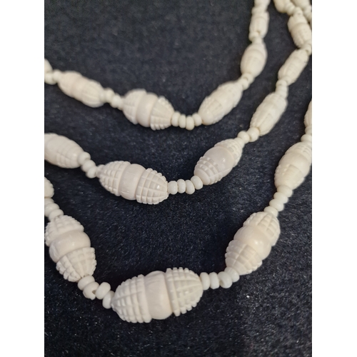 51 - A set of vintage bone necklace and bracelet set and a carved bone triple drop necklace