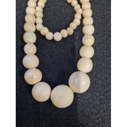 51 - A set of vintage bone necklace and bracelet set and a carved bone triple drop necklace