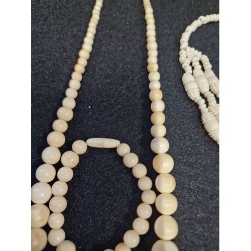 51 - A set of vintage bone necklace and bracelet set and a carved bone triple drop necklace