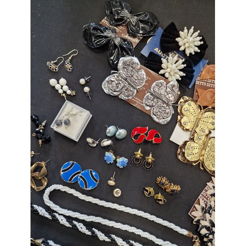 1 - A collection of vintage jewellery including paired earinhs, necklaces, lapel clips, necklaces and br... 