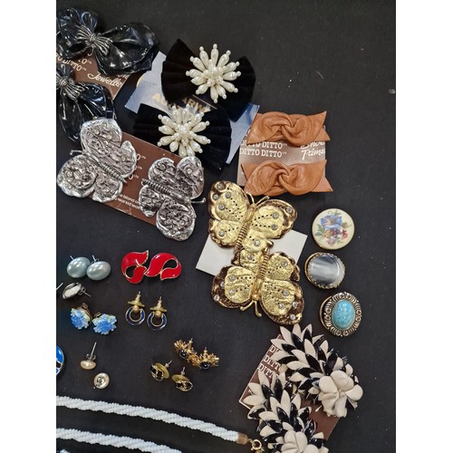 1 - A collection of vintage jewellery including paired earinhs, necklaces, lapel clips, necklaces and br... 