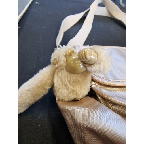 106 - A pale gold Kippling bag with Monkey 