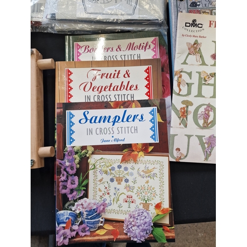 160 - A bundle of cross stitch items, frames, material, cotton and design books