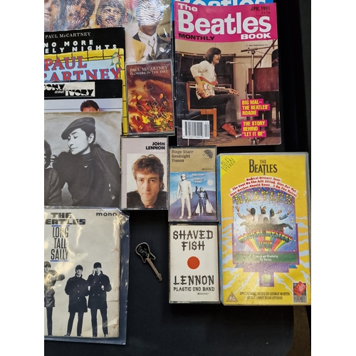 172 - A large collection of the Beatles memorabilia including 13 45's, the fab four calander, the deathles... 