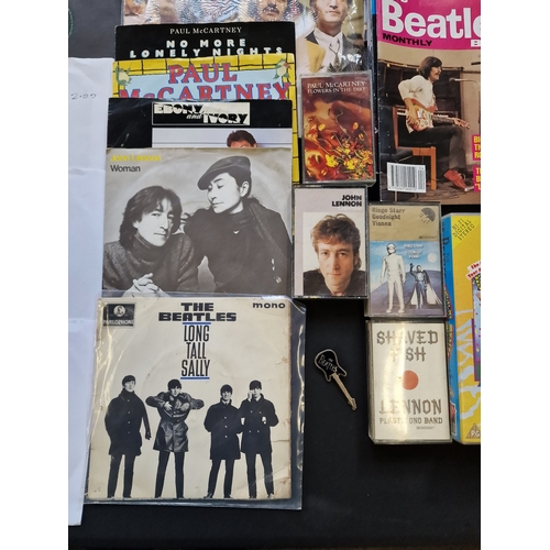 172 - A large collection of the Beatles memorabilia including 13 45's, the fab four calander, the deathles... 