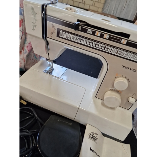 176 - A Toyota sewing machine model no. 2700. Working. Comes with pedal, instructions brand new needles, m... 