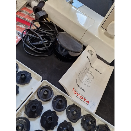 176 - A Toyota sewing machine model no. 2700. Working. Comes with pedal, instructions brand new needles, m... 