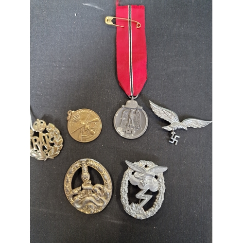 243 - A collection of military memorabilia including RAF badge, Belgium legion rifle medal, WW2 Waffen SS ... 