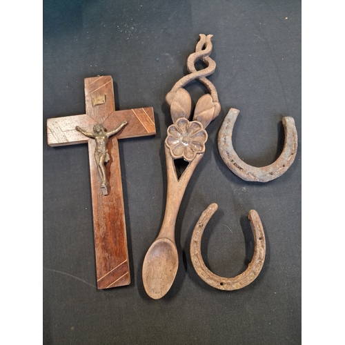 315 - A wooden crucifix with metal jesus approximately30cm, two horses shoes and a wooden hand carved orna... 