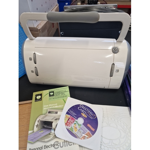 92 - Personal Elctriconic cutter by Cricut with accessories such as cutting boards paper, stencils etc