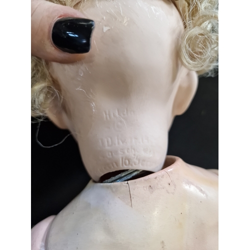 106 - A vintage German porcelain crying doll, has had a replacement head from Germany.  Tip her and she cr... 