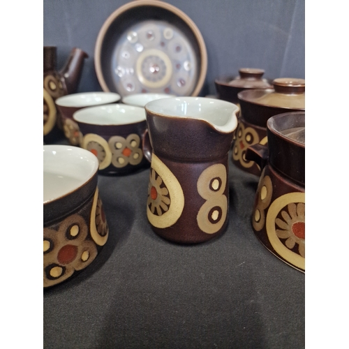 127 - A collection of Denby in Arabesque design.  Includes, sugar bowl, milk jug, three cups, four saucers... 