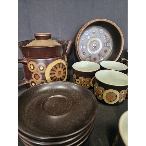 127 - A collection of Denby in Arabesque design.  Includes, sugar bowl, milk jug, three cups, four saucers... 