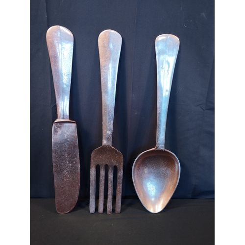 151 - Oversized Copper Coloured Wall Mountable Cutlery Set. Fork, Knife and Spoon. All Approx 60cm Length.