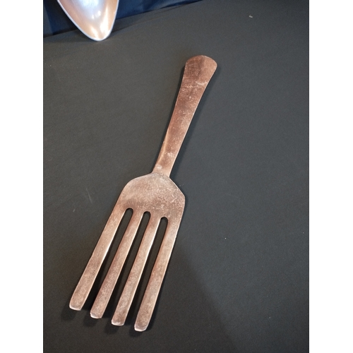 151 - Oversized Copper Coloured Wall Mountable Cutlery Set. Fork, Knife and Spoon. All Approx 60cm Length.