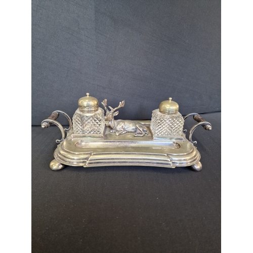 192 - Victorian English Silverplate Ink Stand
An Elk rests between two cut glass ink pots and two quill pe... 