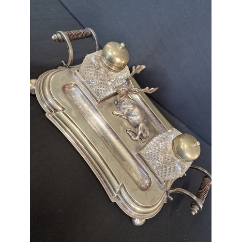 192 - Victorian English Silverplate Ink Stand
An Elk rests between two cut glass ink pots and two quill pe... 