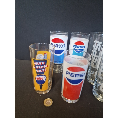 217 - A large collection of vintage PEPSI glass.  10 Different designs. 12 glasses in total.