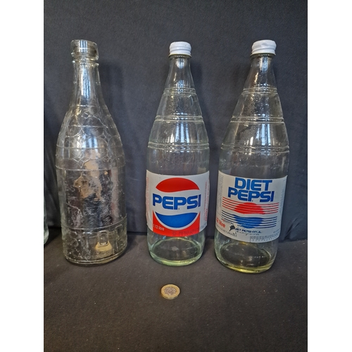 221 - A collection of 1 litre and 1.12 litre PEPSI bottles.  7 different designs, shapes and sizes.