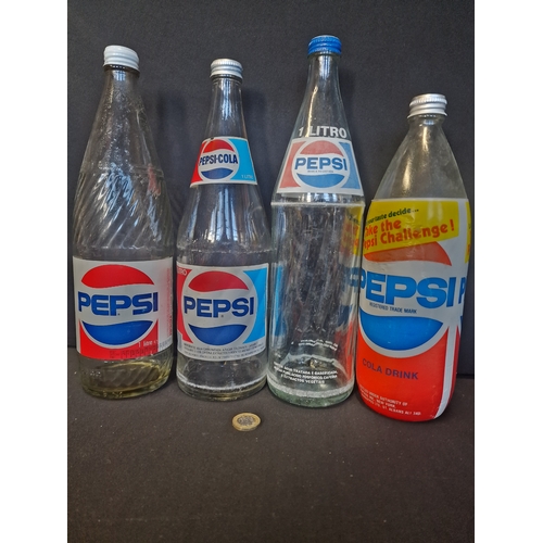 221 - A collection of 1 litre and 1.12 litre PEPSI bottles.  7 different designs, shapes and sizes.