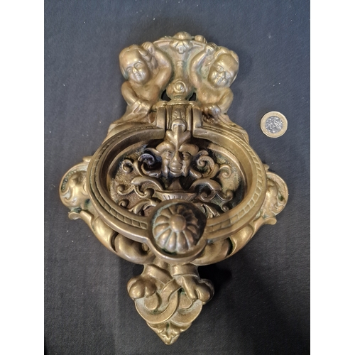 224 - A large and heavy brass cherub door knocker
26x18cm approximately