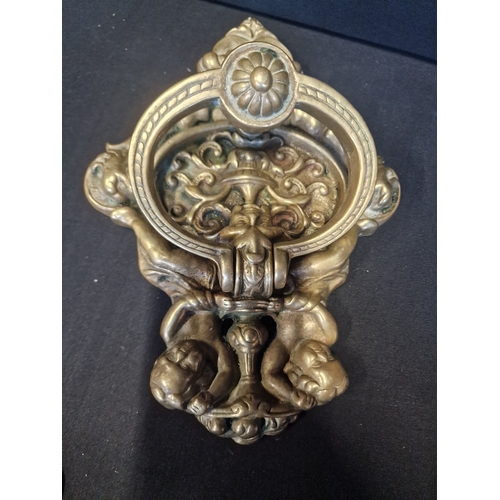 224 - A large and heavy brass cherub door knocker
26x18cm approximately