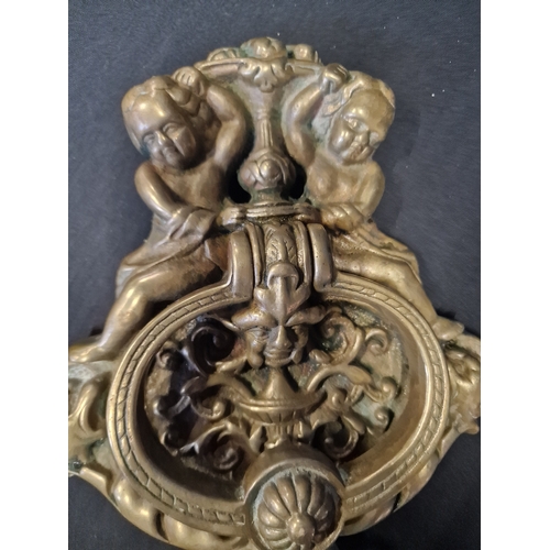 224 - A large and heavy brass cherub door knocker
26x18cm approximately