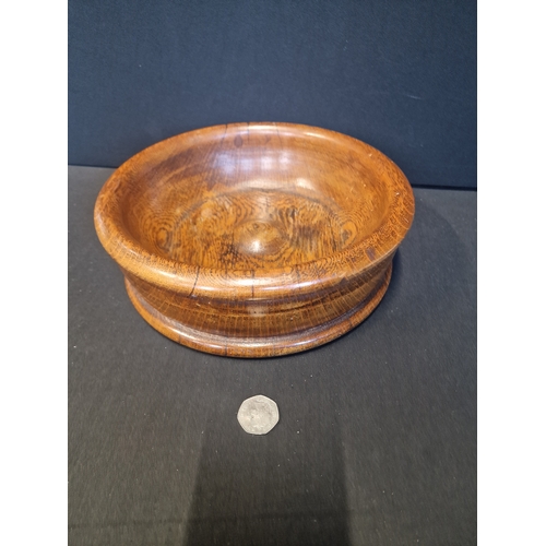 234 - A large Treen oak fruit bowl.  Approximately 26cm in diameter