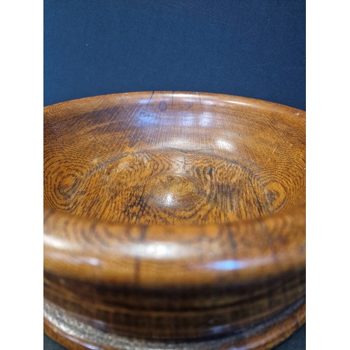 234 - A large Treen oak fruit bowl.  Approximately 26cm in diameter