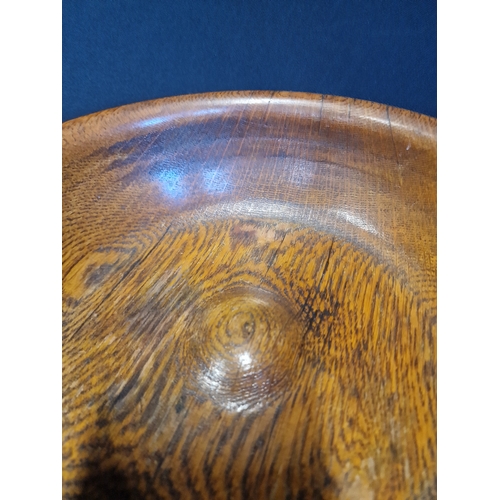 234 - A large Treen oak fruit bowl.  Approximately 26cm in diameter