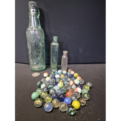 274 - A collection of glass.vintage marbles and bottles