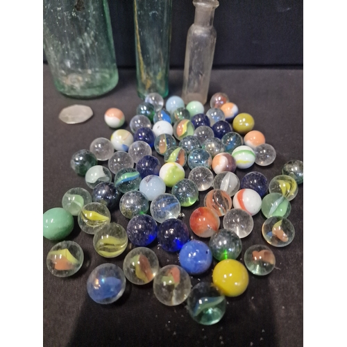 274 - A collection of glass.vintage marbles and bottles