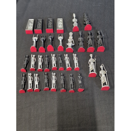 278 - A collection of Egyptian cast metal themed chess pieces