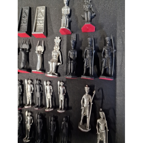 278 - A collection of Egyptian cast metal themed chess pieces