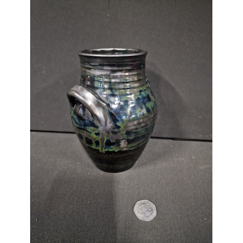 355 - A Michael Edwards Bolingey vase.  Black base colour 7.5 inches tall