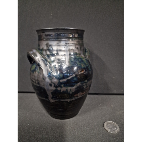 355 - A Michael Edwards Bolingey vase.  Black base colour 7.5 inches tall