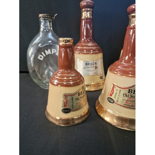 1 - A collection of 7 vintage 1970s BELLS old scotch whiskey Bell  decanters by Wade various sizes and D... 