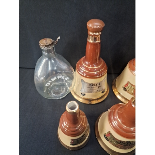 1 - A collection of 7 vintage 1970s BELLS old scotch whiskey Bell  decanters by Wade various sizes and D... 