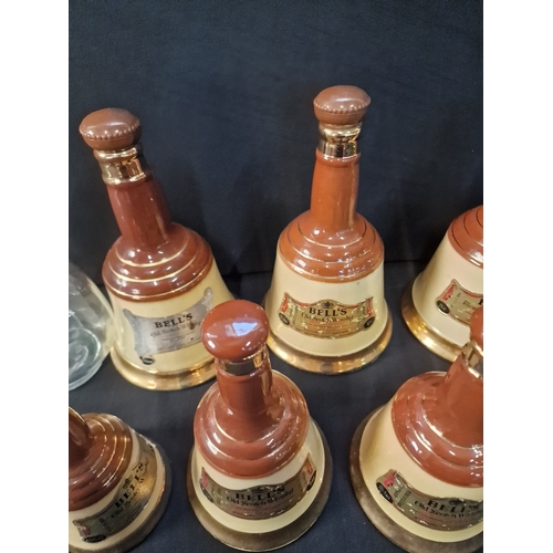 1 - A collection of 7 vintage 1970s BELLS old scotch whiskey Bell  decanters by Wade various sizes and D... 