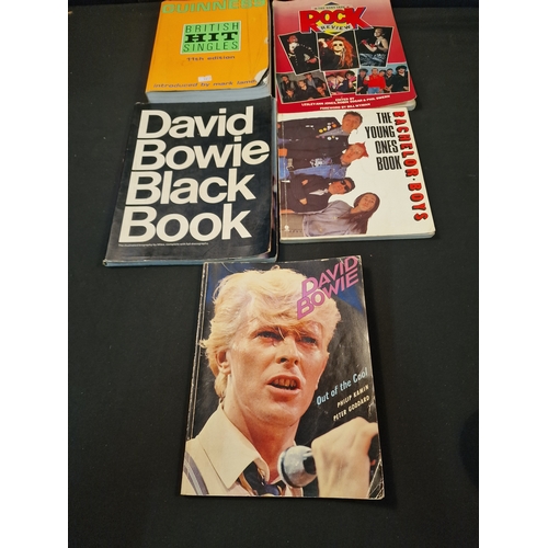 128 - A selection of music books.  Includes David Bowie Black book, David Bowie out of the cool, The Young... 