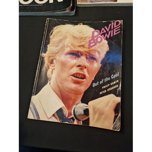 128 - A selection of music books.  Includes David Bowie Black book, David Bowie out of the cool, The Young... 