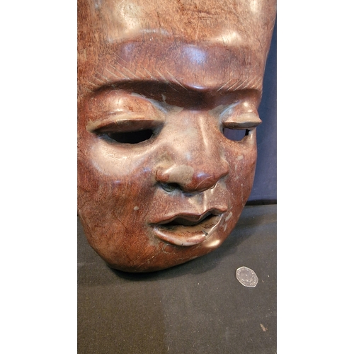 5 - A large wall mounted hand carved tribal head mask. 
Approximately 45x25cm