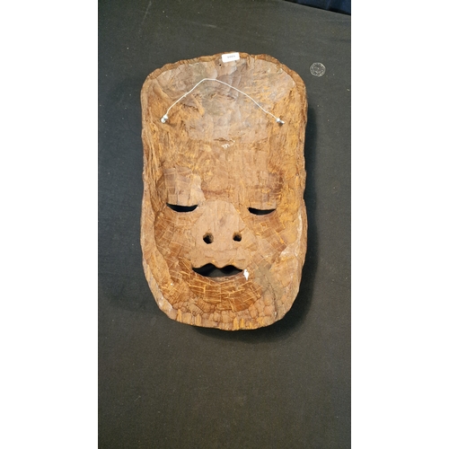 5 - A large wall mounted hand carved tribal head mask. 
Approximately 45x25cm