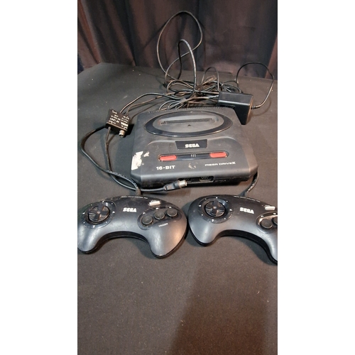 37 - A SEGA mega drive console with two controllers