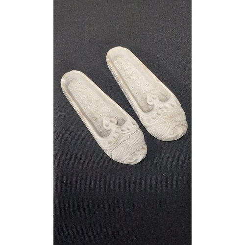 44 - A pair of hand carved stone oriental shoes